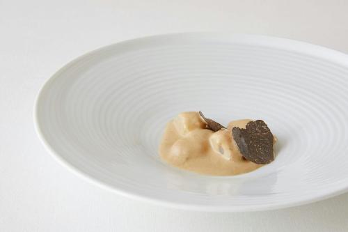 a white plate with a chocolate covered doughnut at Hotel Marqués de Riscal, a Luxury Collection Hotel, Elciego in Elciego