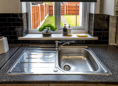 a stainless steel sink in a kitchen with a window at TheHaven in Wolverhampton