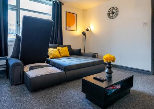 a living room with a couch and a coffee table at TheHaven in Wolverhampton