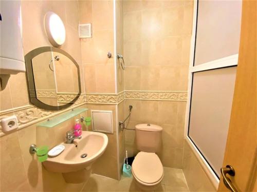 a small bathroom with a toilet and a sink at Bravo 5 Apartments in Sunny Beach