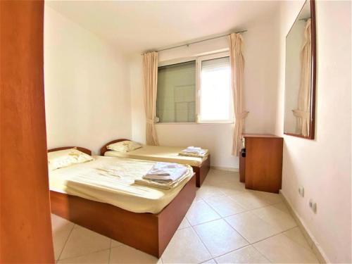 two beds in a small room with a window at Bravo 5 Apartments in Sunny Beach