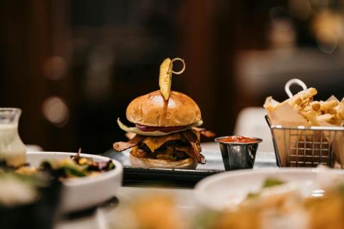a sandwich sitting on a table with fries at The Westin Jackson in Jackson