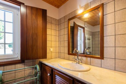 a bathroom with a sink and a mirror at Cerca Velha Alentejo House in Cercal