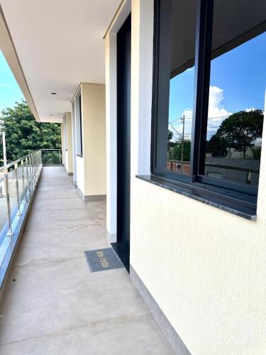 a corridor of a building with windows and a sidewalk at Flats Luxo - Apartamentos 2 Quartos com Garagem in Palmas