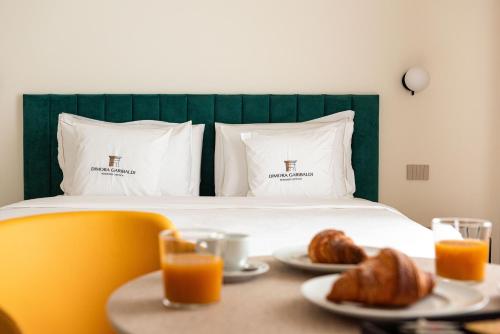 Katil atau katil-katil dalam bilik di Suites Dimora Garibaldi