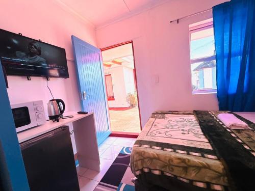 a bedroom with a bed and a tv in a room at Executive Accommodation Bellville 2 in Cape Town