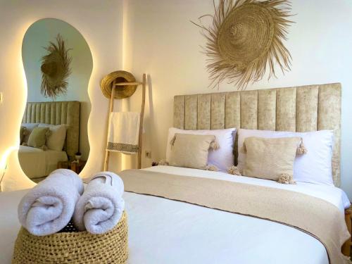 a bedroom with a bed with towels on it at S&H Home Martil Apartment in Martil