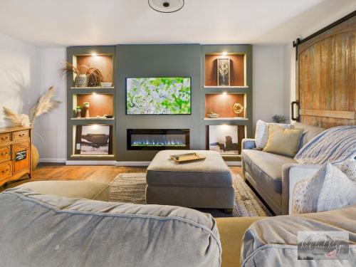 a living room with a couch and a tv at Beautiful Country Apartment, AC, Pickleball, Billiards, Playground, Gardens in Philomath