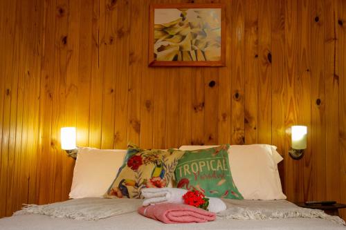 a bedroom with a bed with two stuffed animals on it at Casitas Nuova Villa in Puerto Iguazú
