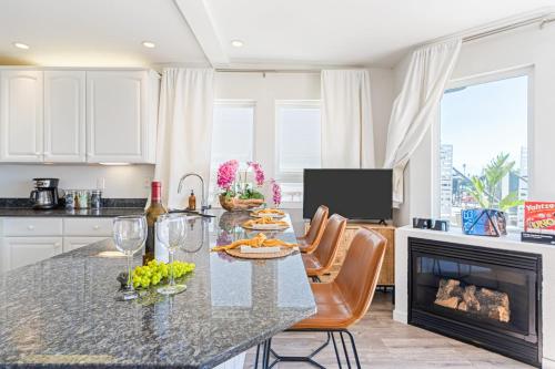 a kitchen with a table with wine glasses and a fireplace at 2 Coastal Studios at Cayucus Beach Access Ocean Views in Cayucos