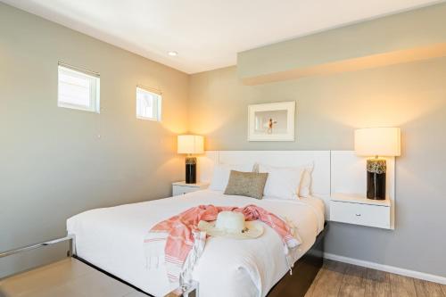 a bedroom with a white bed and two lamps at 4 Cayucos Bungalows Steps to Beach Sleeps 16 Pet Friendly in Cayucos