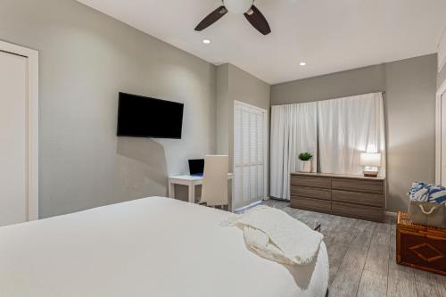 a bedroom with a bed and a flat screen tv at 4 Cayucos Bungalows Steps to Beach Sleeps 16 Pet Friendly in Cayucos