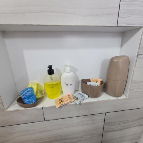a shelf with bottles and other items in a drawer at Dpto cerca de COP Comité Olímpico Paraguayo in Luque