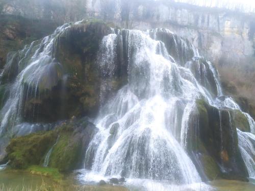 a waterfall on the side of a mountain at chambre d hôtes Ferme Bressane la barcarolle in Dommartin-lès-Cuiseaux