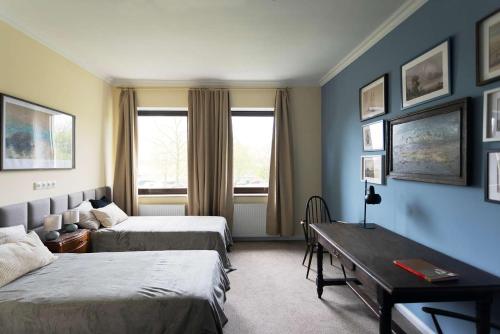 a hotel room with two beds and a table at Big Premium Apartment with Rhine View, totally new in Duisburg