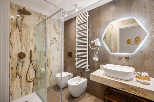 a bathroom with a toilet and a sink and a shower at Casta Diva Fervore Apartments Self Check-in in Palermo