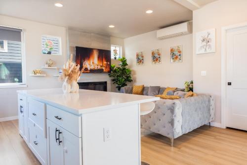 a kitchen and living room with a couch and a fireplace at Utopia Luxury Stay - Lynwood in Lynnwood