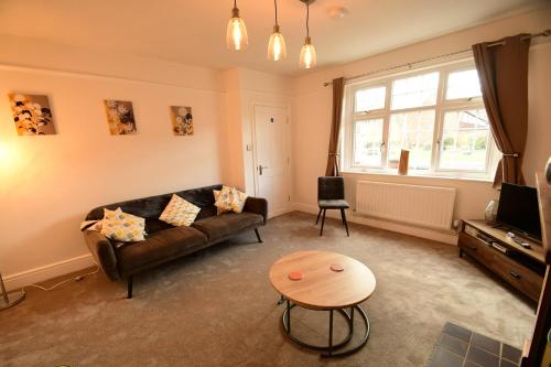 a living room with a couch and a table at Old Street Terrace in Ludlow