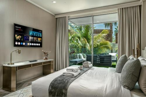 a bedroom with a large bed and a television at FIVE Palm Jumeirah Premier Apartments in Dubai