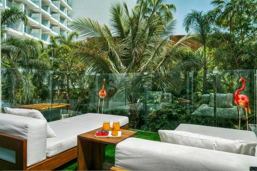 a patio with two white couches and flamingos on it at FIVE Palm Jumeirah Premier Apartments in Dubai