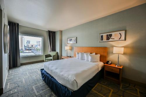 a hotel room with a large bed and a window at StripViewSuites at Platinum in Las Vegas