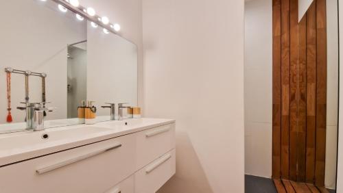 a bathroom with a sink and a mirror at Villa des Oliviers in Aigues-Vives