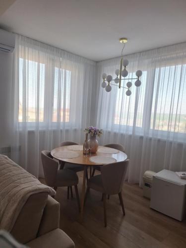 a dining room table and chairs in a room at DIAMOND - Luxusný Apartmán Marco in Podhájska