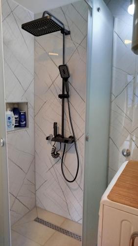 a shower with a hair dryer in a bathroom at Pyramid Gardens in Visoko
