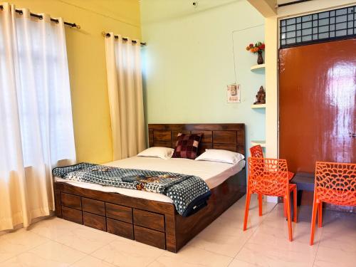 a bedroom with a bed and a table and chairs at Jai Villa Homestay in Prayagraj