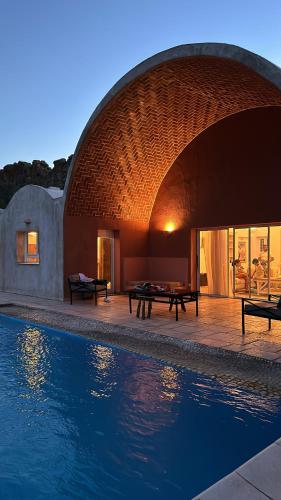 a building with a pool of water in front of it at Dar El Monchar in Hammamet