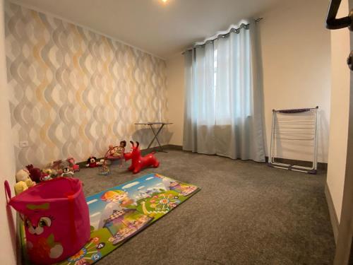 a childs room with toys on the floor at Family House in Aghtsʼkʼ