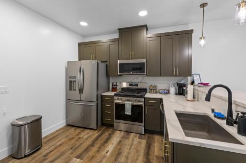 a kitchen with stainless steel appliances and wooden cabinets at Cozy Spacious Retreat with Fireplace 205 in Juneau