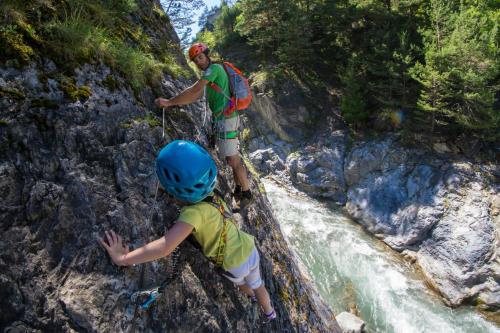 a man and a child climbing on a waterfall at Chalet d'alpage au coeur du Parc naturel du Queyras - exceptionnel in Valpreveyre