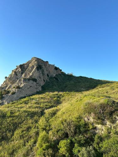 a mountain on top of a grassy hill at Rocks View Apartment in Durrës