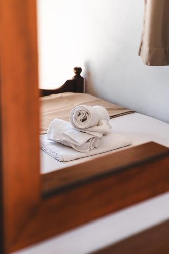 a mirror reflection of two beds with towels on them at Μpasias Apartments in Paralia Katerinis