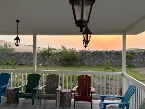 a group of chairs sitting on a porch at Prairie in Al Khaznah