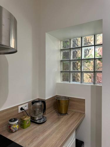 - une cuisine avec un comptoir en bois et une fenêtre dans l'établissement Le pétillant - cathédrale, à Reims