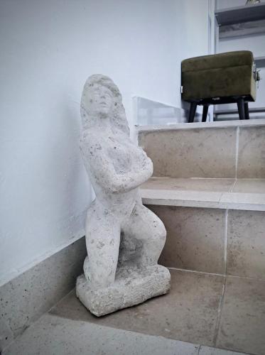 a statue of a person leaning against a wall at Villa Stone House Poplat in Vela Luka