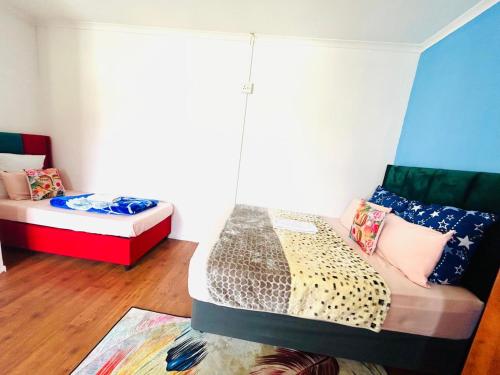 a living room with two beds and a couch at Executive Accommodation Bellville 2 in Cape Town
