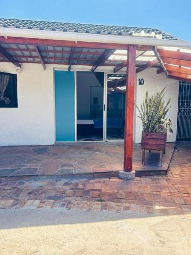 a pavilion with a bench in front of a building at Executive Accommodation Bellville 2 in Cape Town