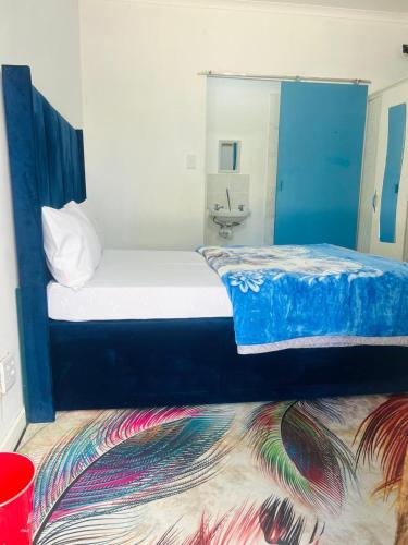 a bedroom with a bed with a mirror and a rug at Executive Accommodation Bellville 2 in Cape Town