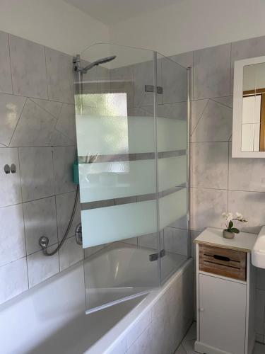 a bathroom with a shower with a tub and a sink at Ferien im Schwarzwald - Ruhe & naturverbunden in Weilheim