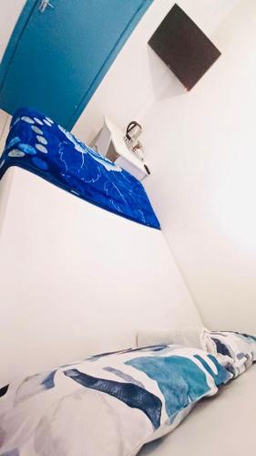 a bedroom with a bed with a blue head board at Executive Accommodation Bellville 2 in Cape Town