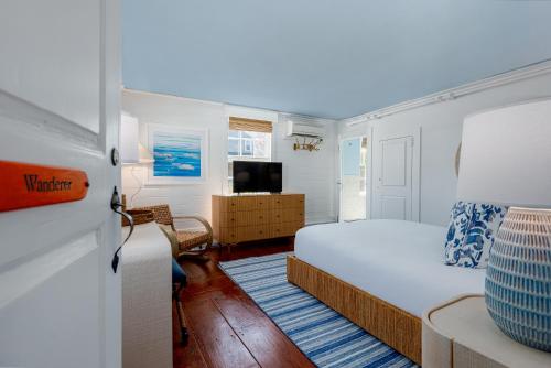 a bedroom with a bed and a television in it at Anchor Inn in Nantucket