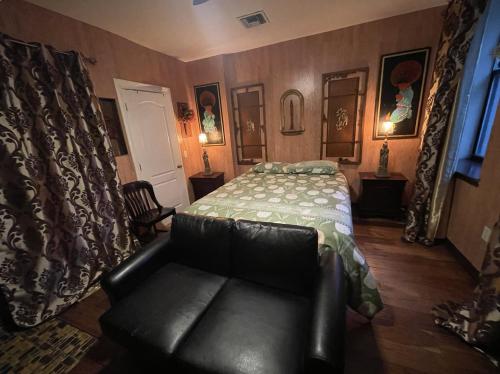 a bedroom with a bed and a couch in it at NYC Townhouse Apartment in New York