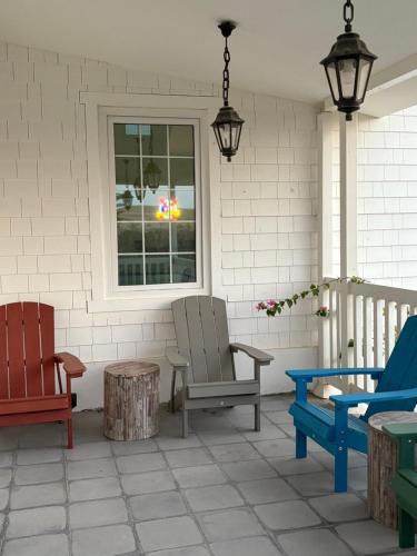 a patio with two chairs and a window at Prairie in Al Khaznah