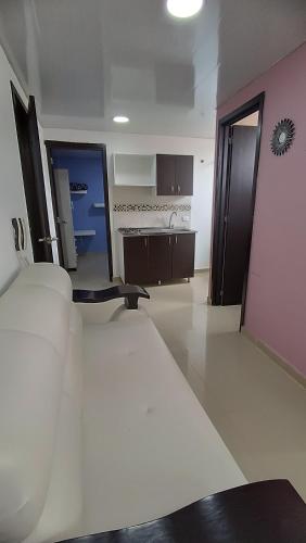 a large room with a bed and a kitchen at Hotel Blue in Santa Rosa de Cabal