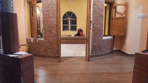 a bathroom with a sink and a mirror at Kheya Kutir in Shānti Niketan