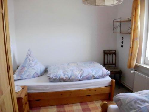 a bed with pillows on it in a room at Holiday apartment with 2 bedrooms in Bad Harzburg