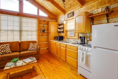 a kitchen with a couch and a stove top oven at Rivers View - Cherokee Lake Cabin with Fire Pit! in Bean Station